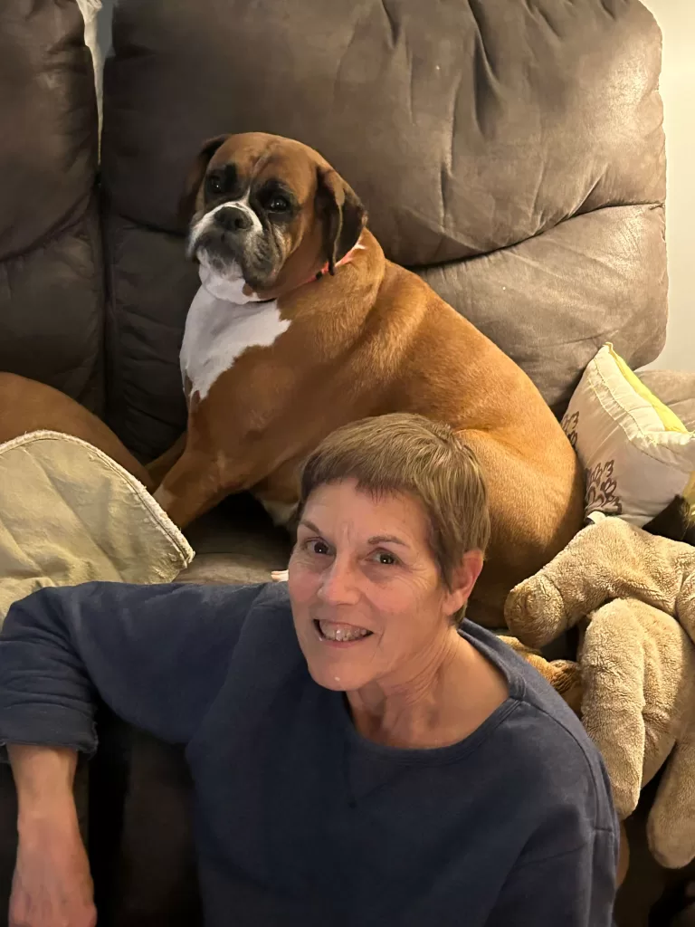 How to Choose a Boxer Dog - Phot of our adopted Boxer Katie on a couch with author